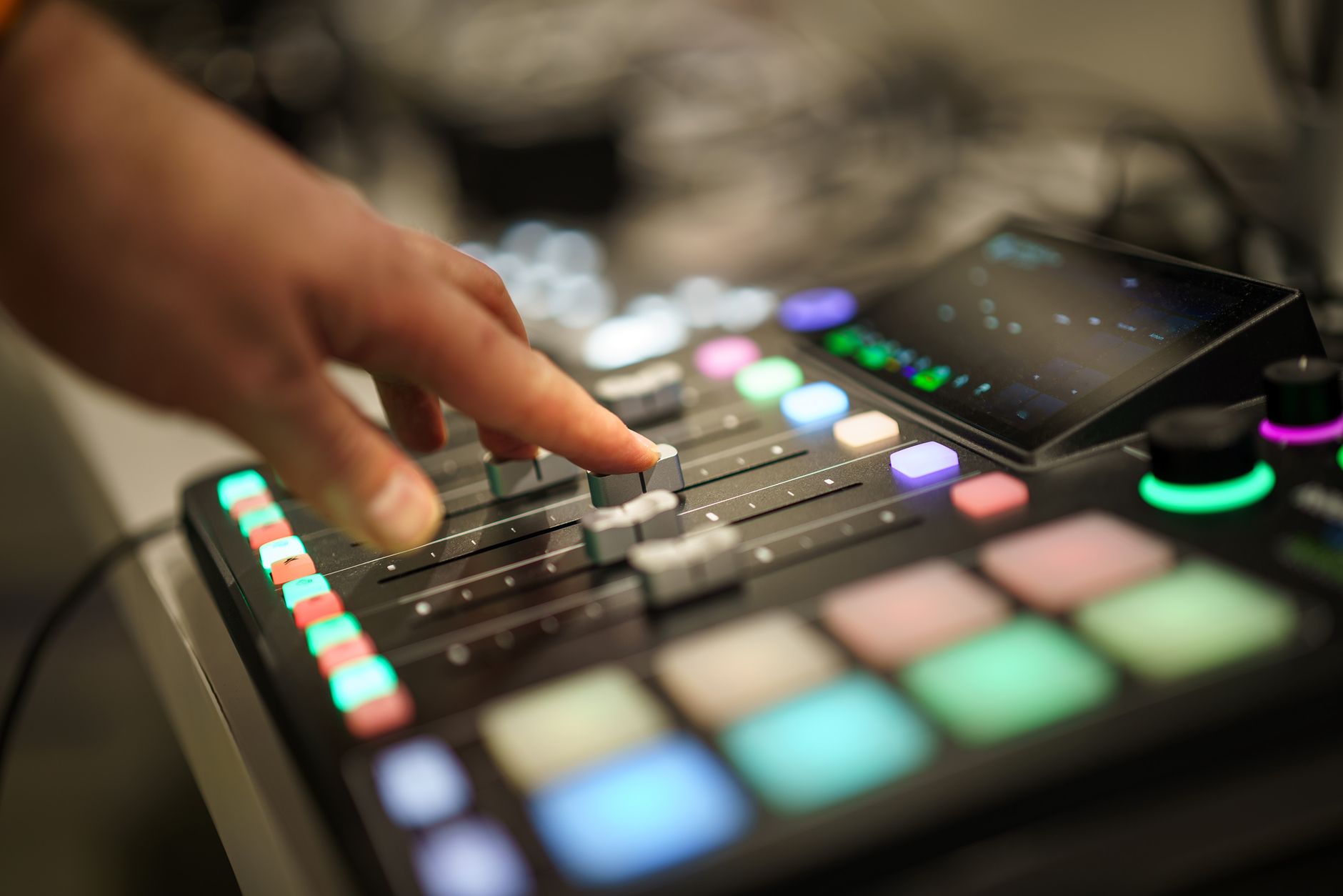 Sound technician adjusting levels on mixer board