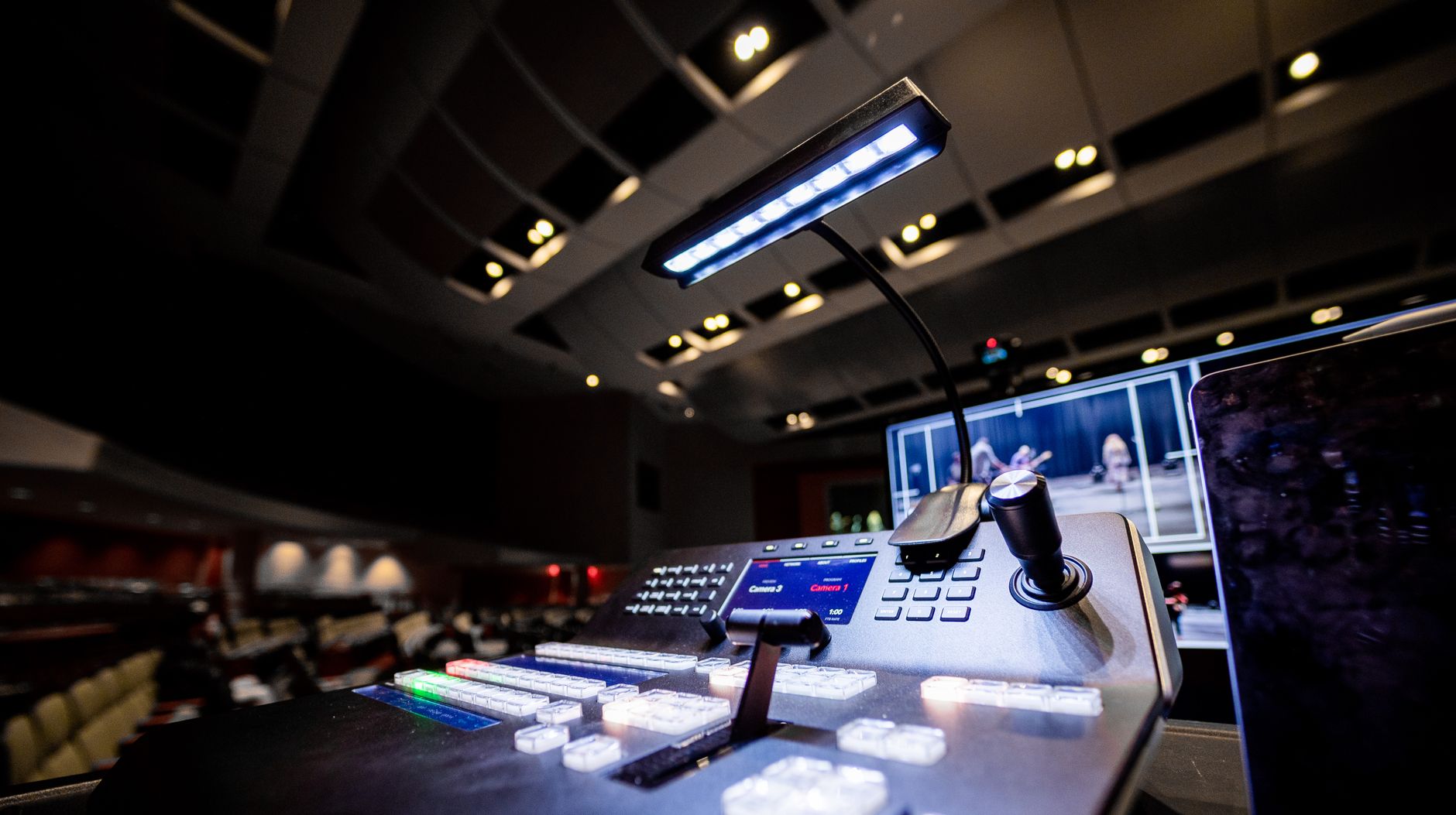 A broadcast control deck with colorful buttons