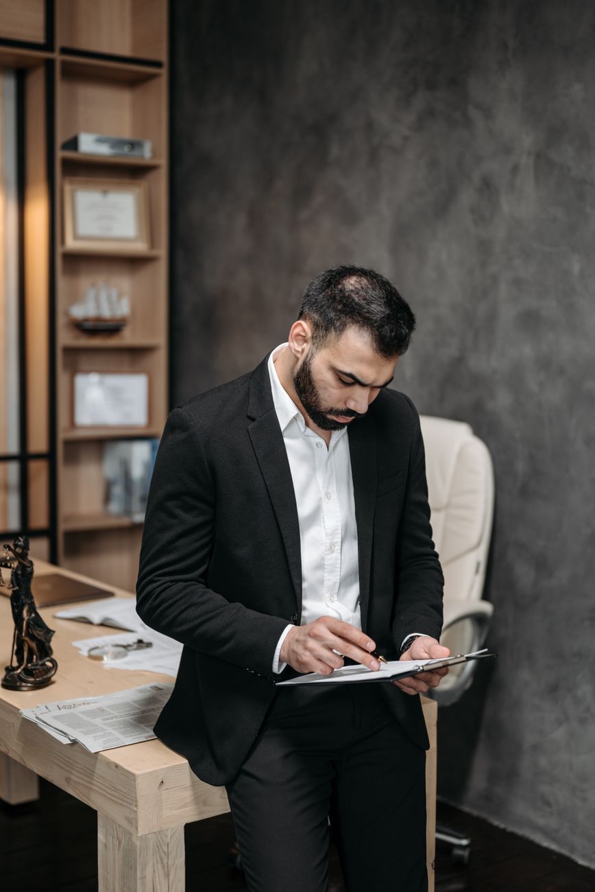 A compliance legal auditor reviewing broadcasting documents